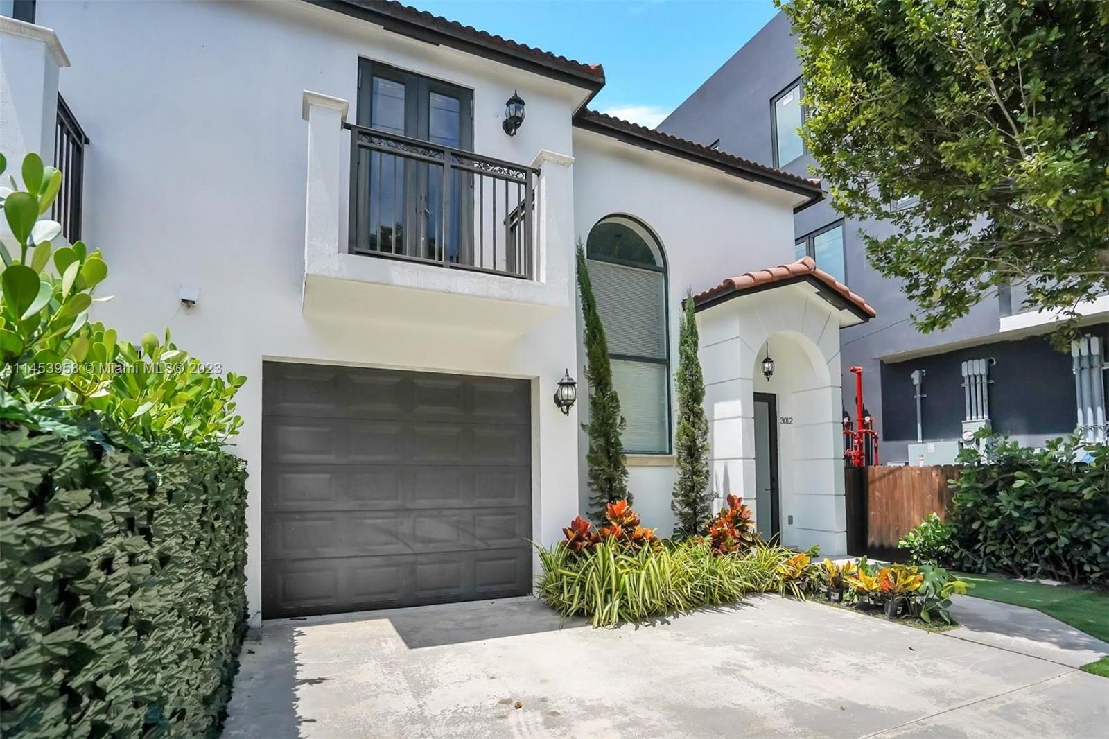 3012 Elizabeth Street, Unit 3012 Miami, FL 33133 - Photo 1 of 27 a front view of a house with garden