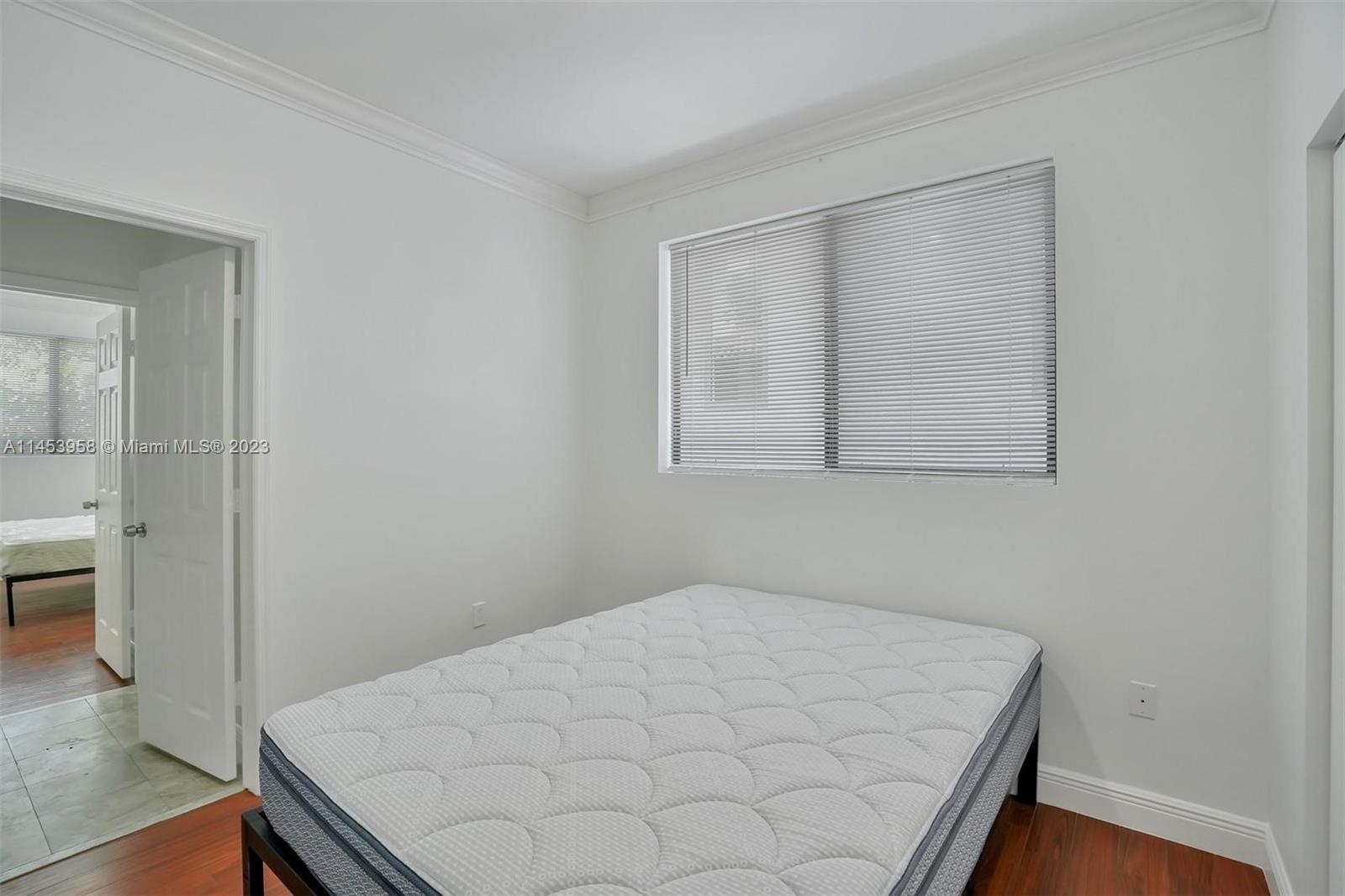 3012 Elizabeth Street, Unit 3012 Miami, FL 33133 - Photo 13 of 27 a room with a bed and a table
