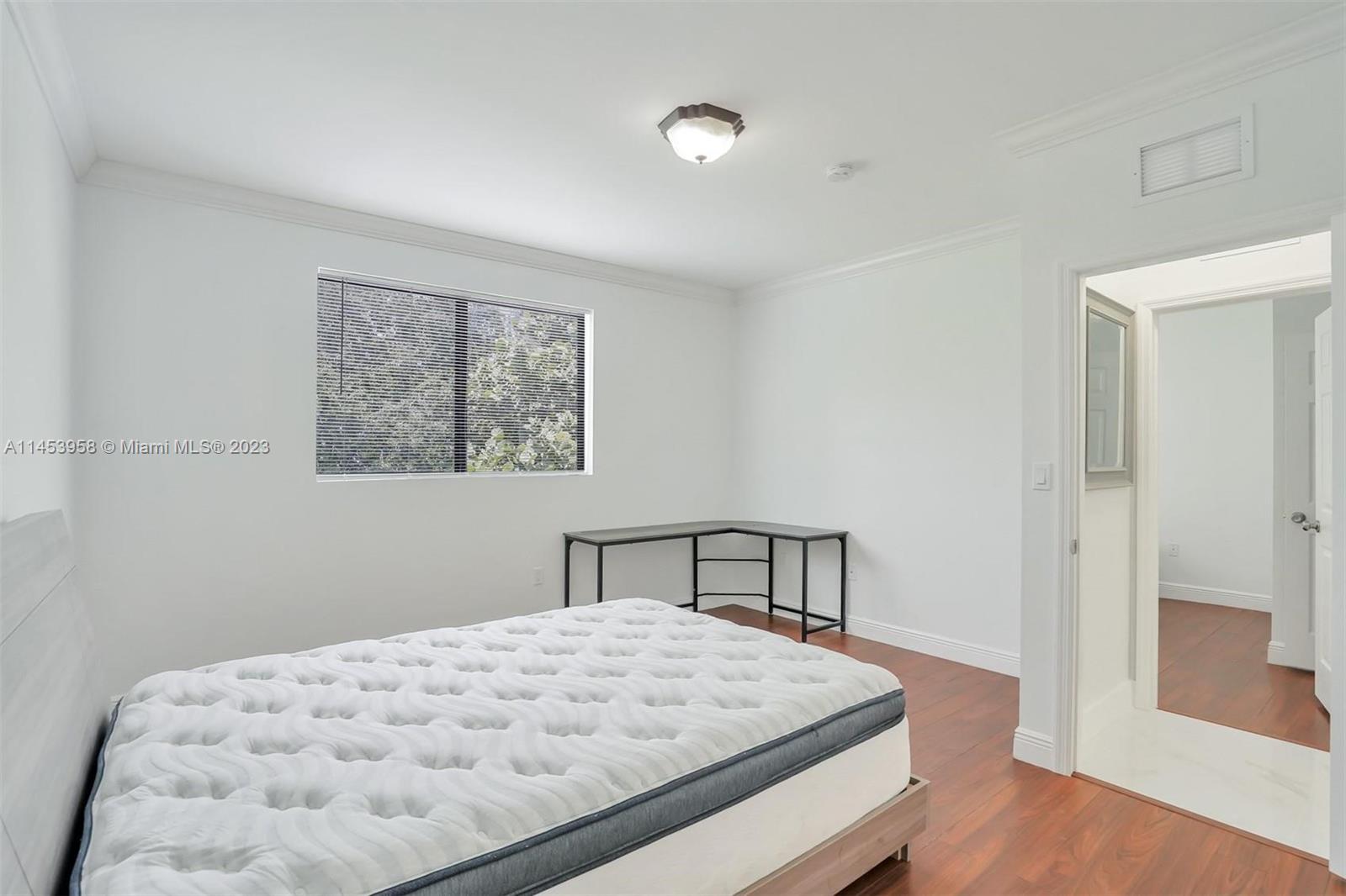 3012 Elizabeth Street, Unit 3012 Miami, FL 33133 - Photo 14 of 27 a bedroom with a bed and a window