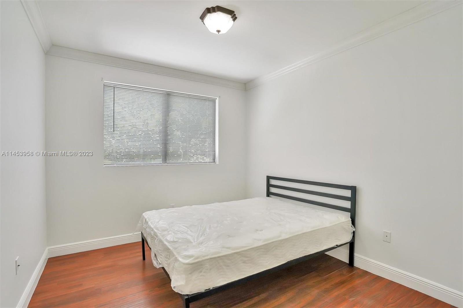 3012 Elizabeth Street, Unit 3012 Miami, FL 33133 - Photo 17 of 27 a bedroom with a bed and a window