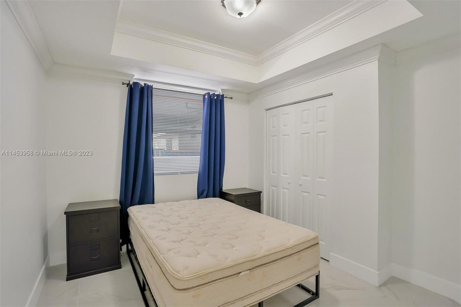 3012 Elizabeth Street, Unit 3012 Miami, FL 33133 - Photo 19 of 27 a bedroom with a bed and a table
