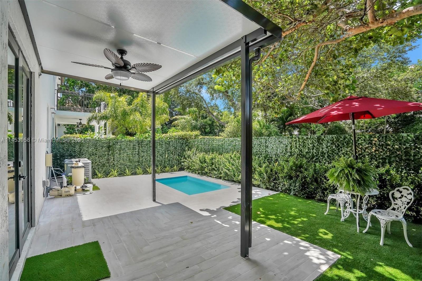 3012 Elizabeth Street, Unit 3012 Miami, FL 33133 - Photo 2 of 27 a view of a patio with a table chairs and a backyard