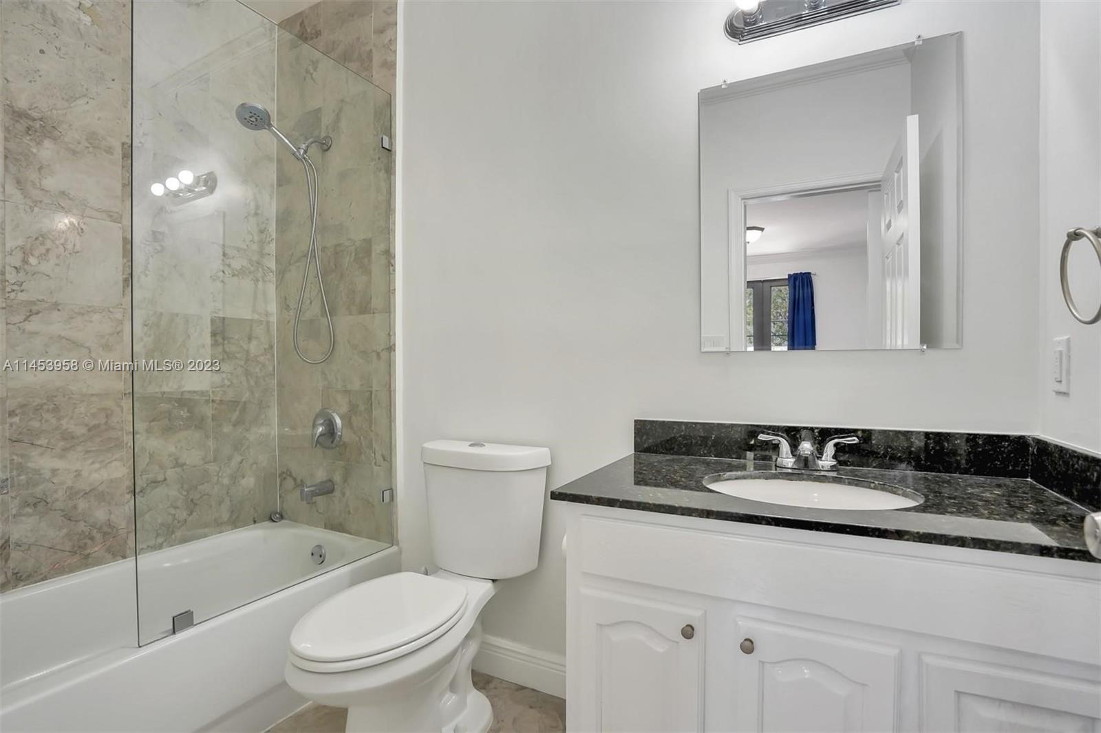 3012 Elizabeth Street, Unit 3012 Miami, FL 33133 - Photo 22 of 27 a white toilet sitting next to a bathroom sink