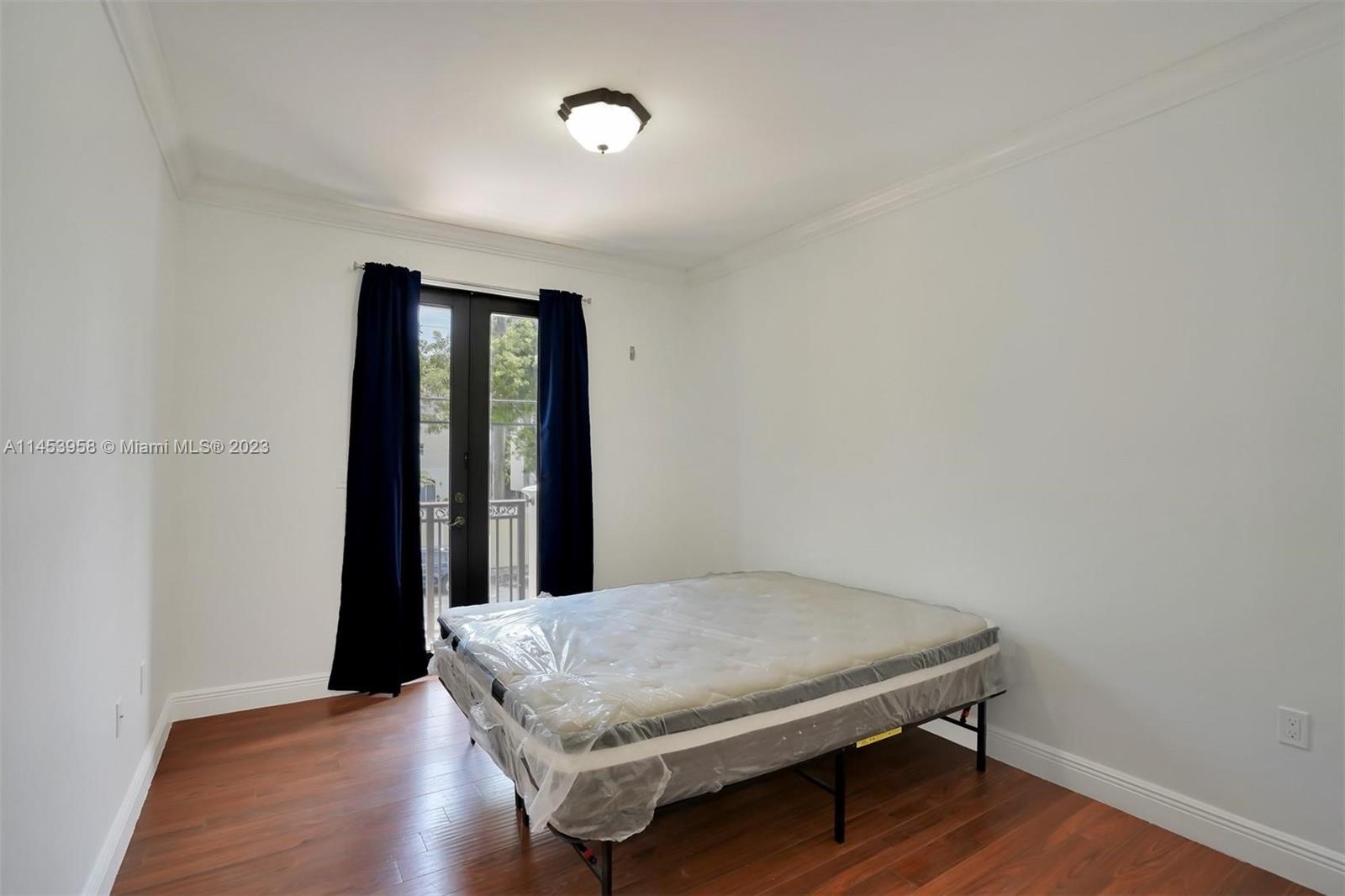 3012 Elizabeth Street, Unit 3012 Miami, FL 33133 - Photo 23 of 27 a bedroom with a bed and a window