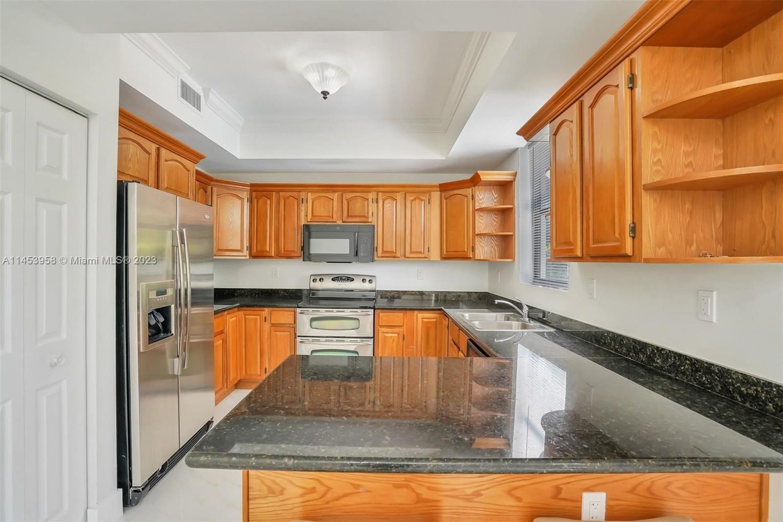 3012 Elizabeth Street, Unit 3012 Miami, FL 33133 - Photo 25 of 27 a kitchen with stainless steel appliances granite countertop a sink window and cabinets