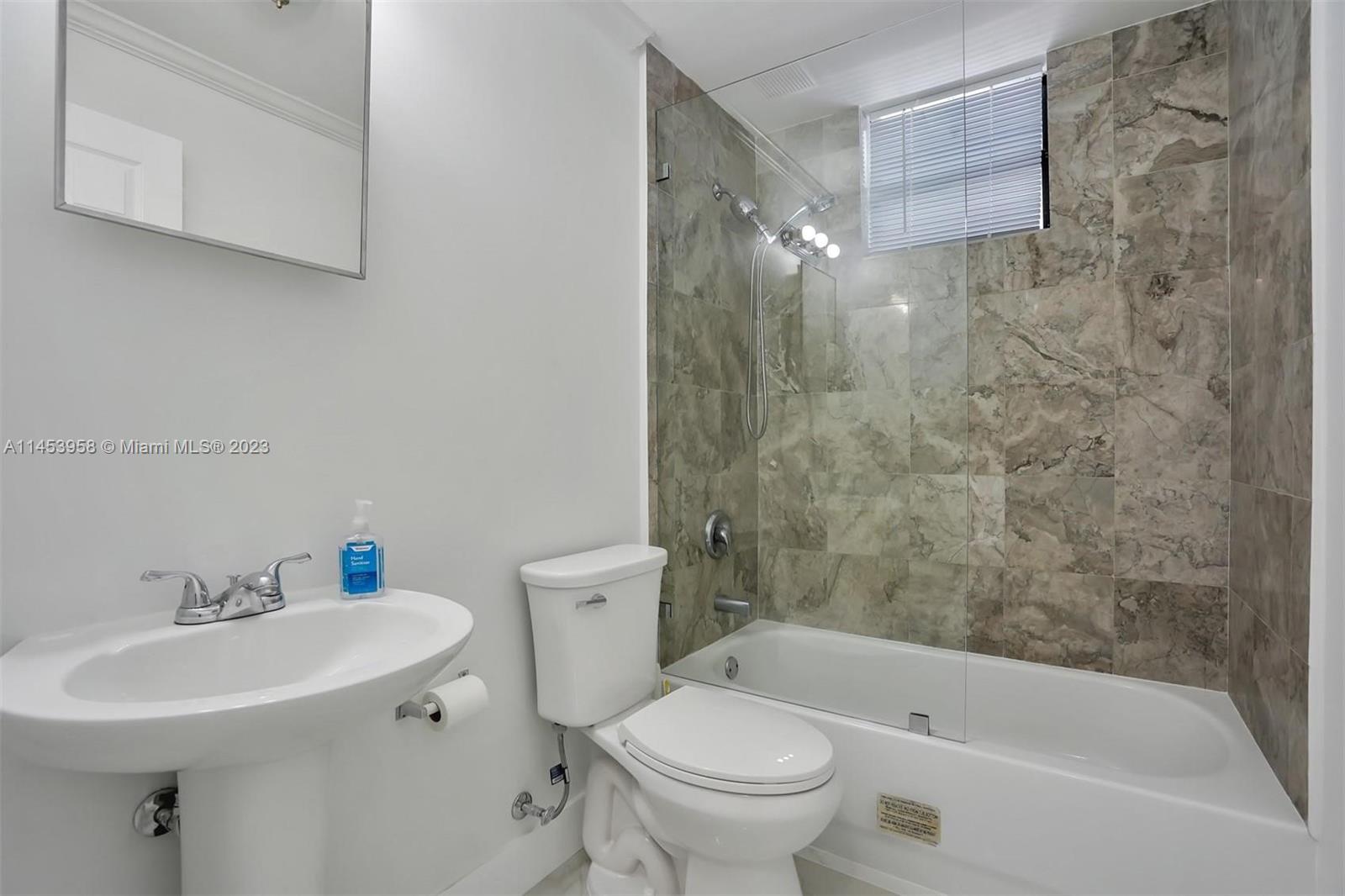 3012 Elizabeth Street, Unit 3012 Miami, FL 33133 - Photo 9 of 27 a bathroom with a sink toilet and shower