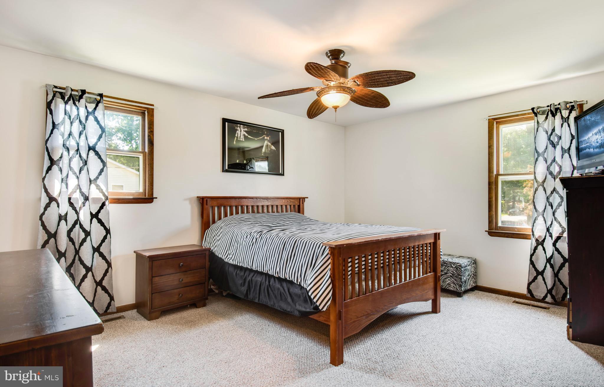 1831 Potomac Road Edgewater, MD 21037 - Photo 11 of 27 a bedroom with a bed and a chandelier