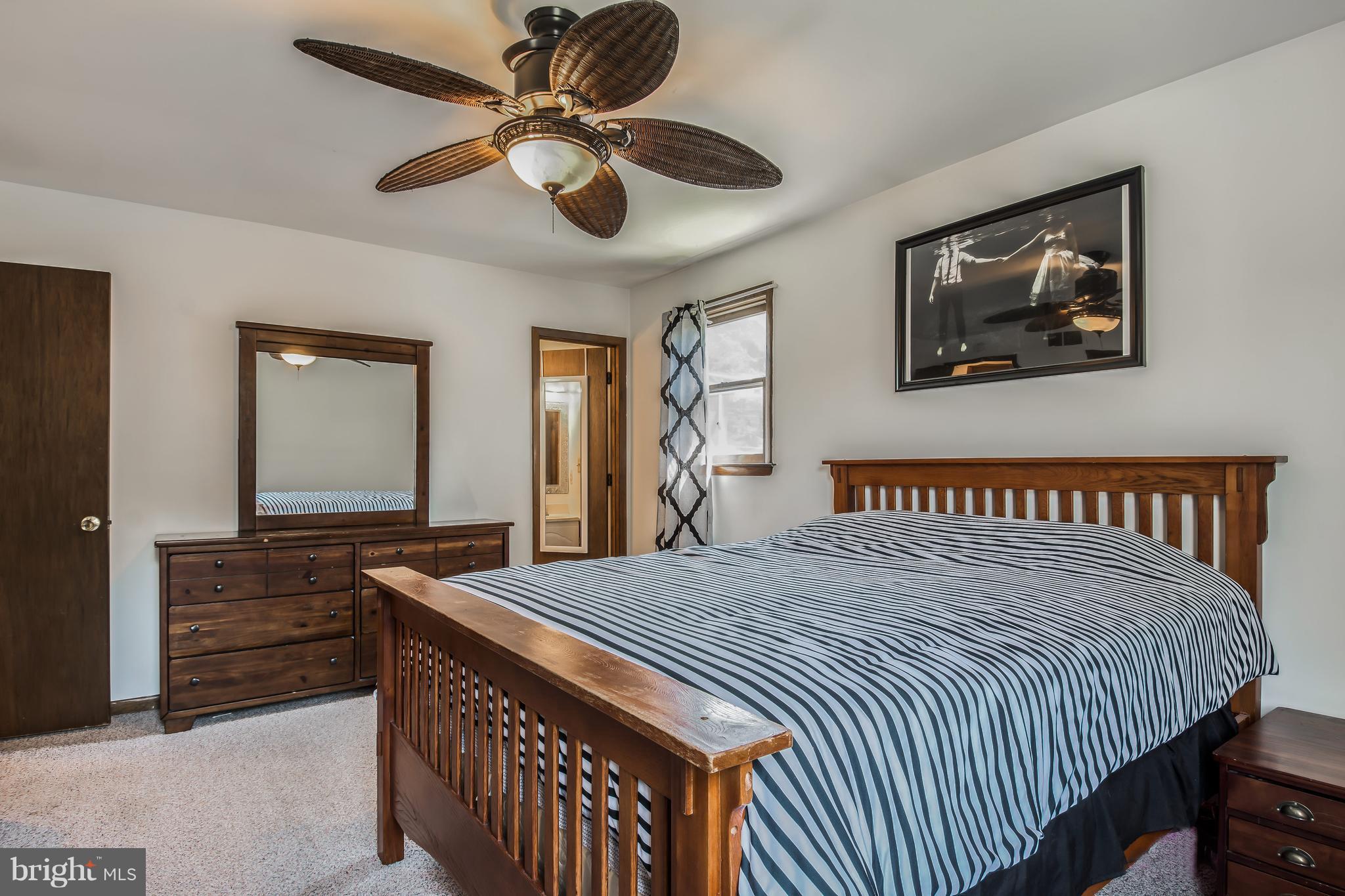1831 Potomac Road Edgewater, MD 21037 - Photo 12 of 27 a bedroom with a bed and a chandelier