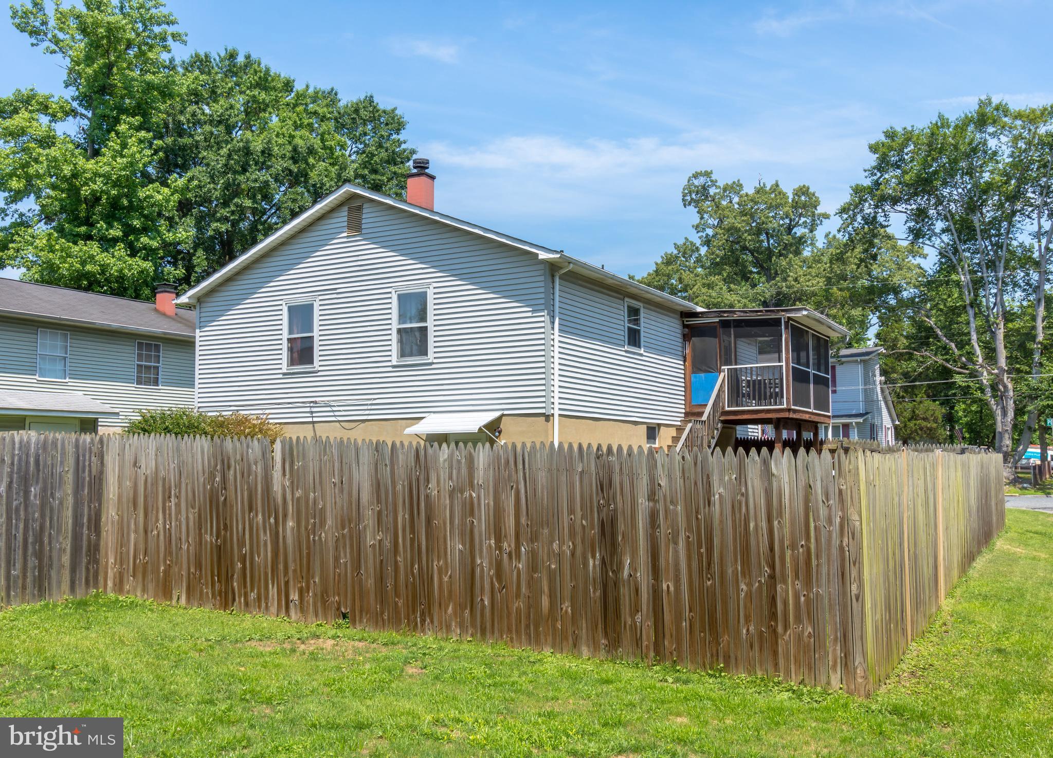 1831 Potomac Road Edgewater, MD 21037 - Photo 26 of 27 a front view of a house with a garden and trees