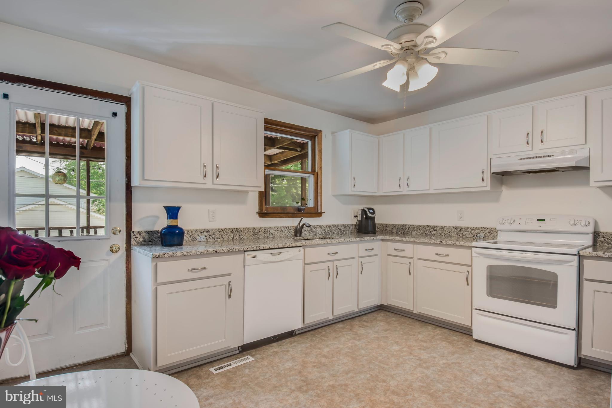 1831 Potomac Road Edgewater, MD 21037 - Photo 4 of 27 a kitchen with granite countertop a sink stainless steel appliances and cabinets