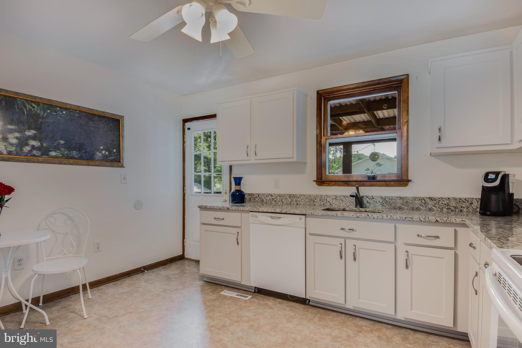 1831 Potomac Road Edgewater, MD 21037 - Photo 5 of 27 a kitchen with granite countertop a sink a window and cabinets