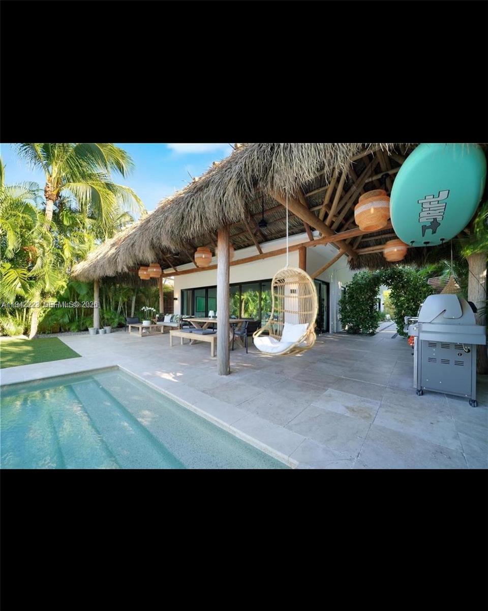 811 86th Street Miami Beach, FL 33141 - Photo 3 of 13 a view of a swimming pool with a patio