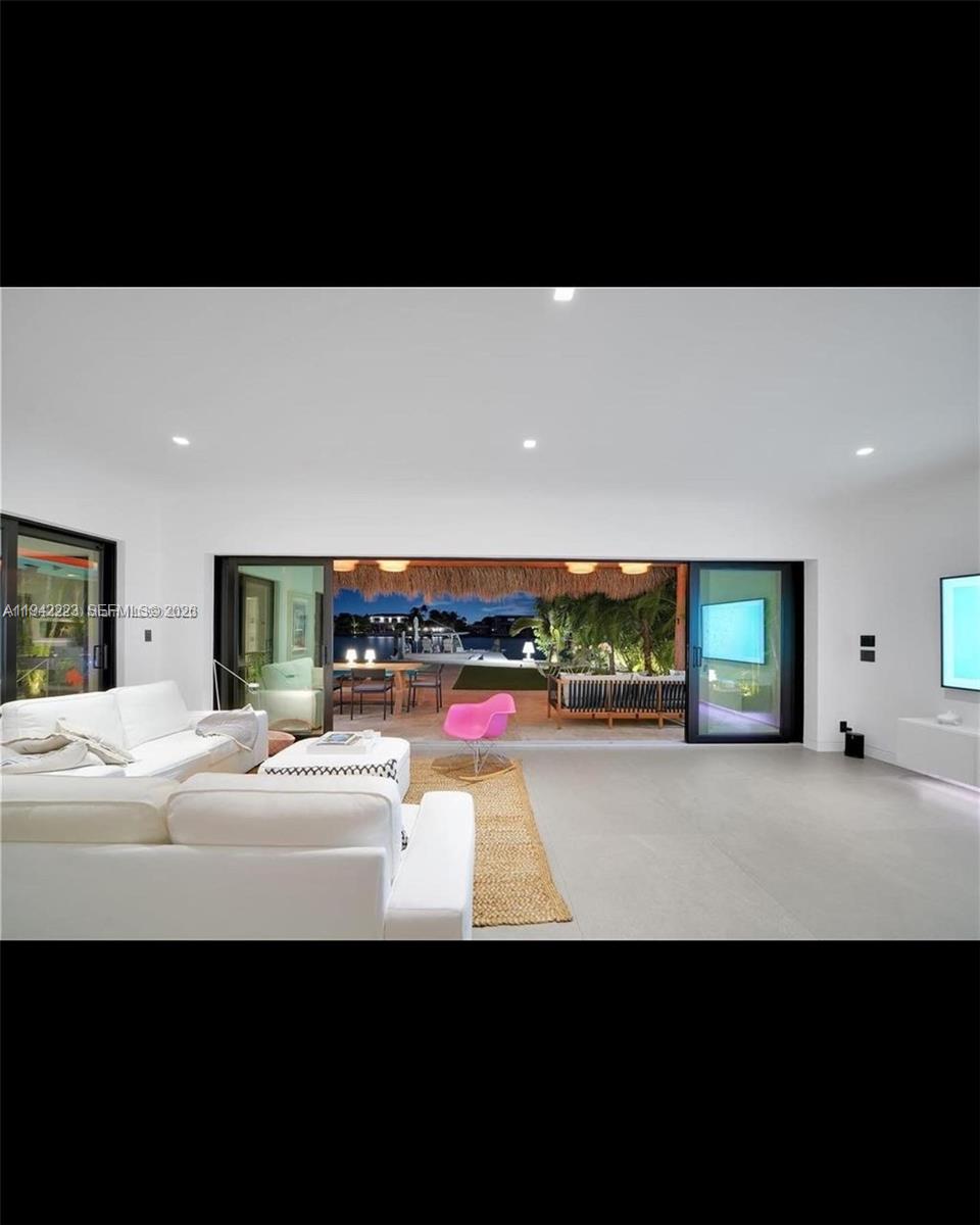 811 86th Street Miami Beach, FL 33141 - Photo 9 of 13 a living room with furniture and a flat screen tv