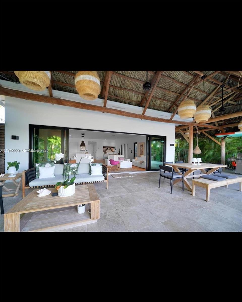 811 86th Street Miami Beach, FL 33141 - Photo 10 of 13 a view of a patio with table and chairs and potted plants