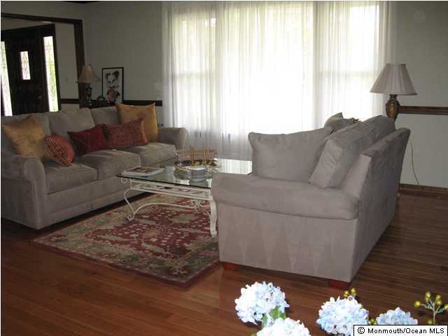 801 Lovett Road Colts Neck, NJ 07722 - Photo 3 of 3 a living room with furniture wooden floor and a window