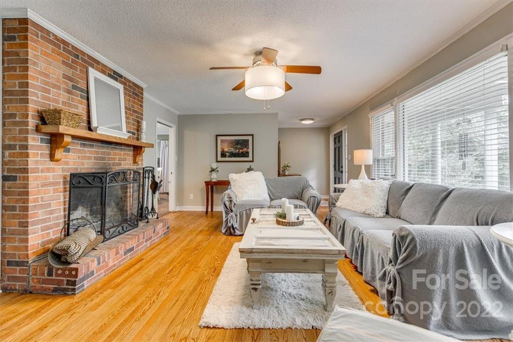 740 North Beersheba Road Clover, SC 29710 - Photo 8 of 46 a living room with furniture a fireplace and a large window