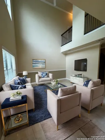 a living room with furniture and a flat screen tv
