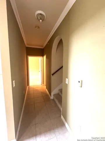 a view of staircase with white walls and a window