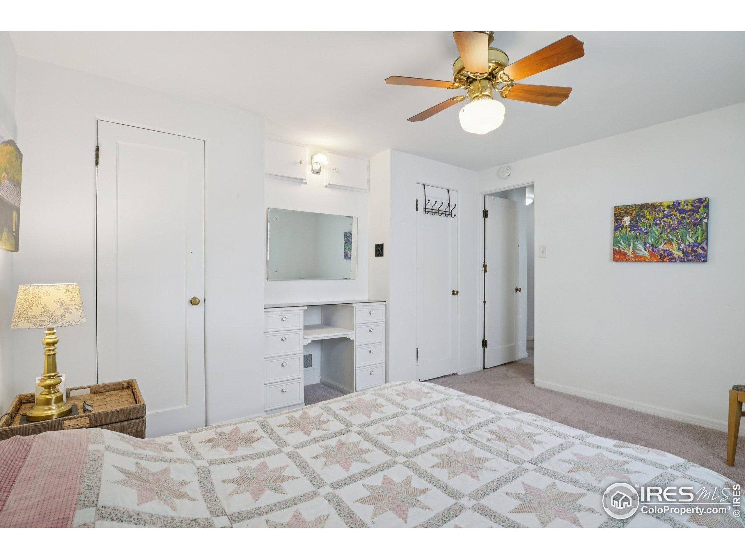 1110 South Quitman Street Denver, CO 80219 - Photo 20 of 43 a bedroom with a bed and a chandelier