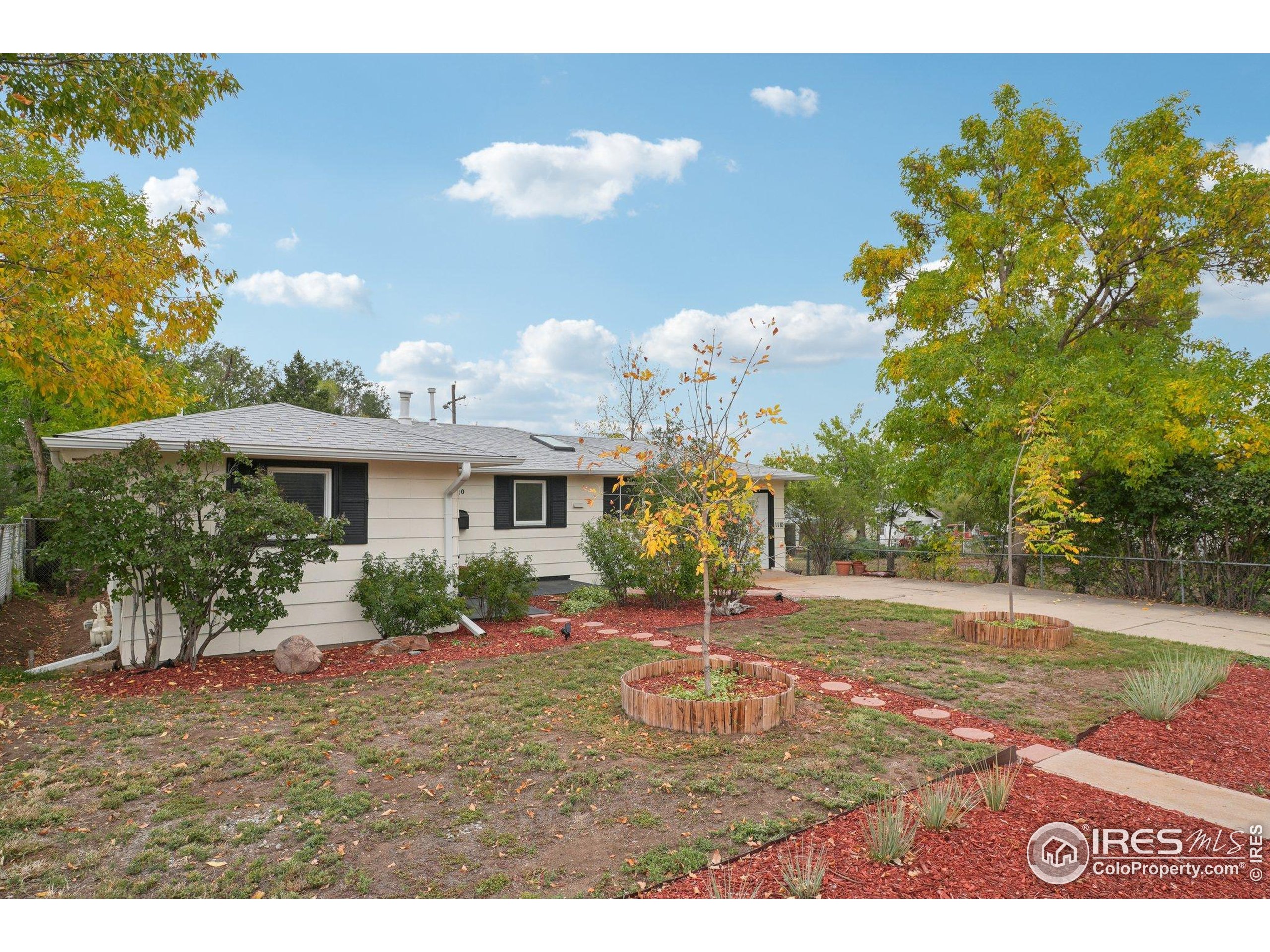 1110 South Quitman Street Denver, CO 80219 - Photo 2 of 43 a backyard of a house with table and chairs