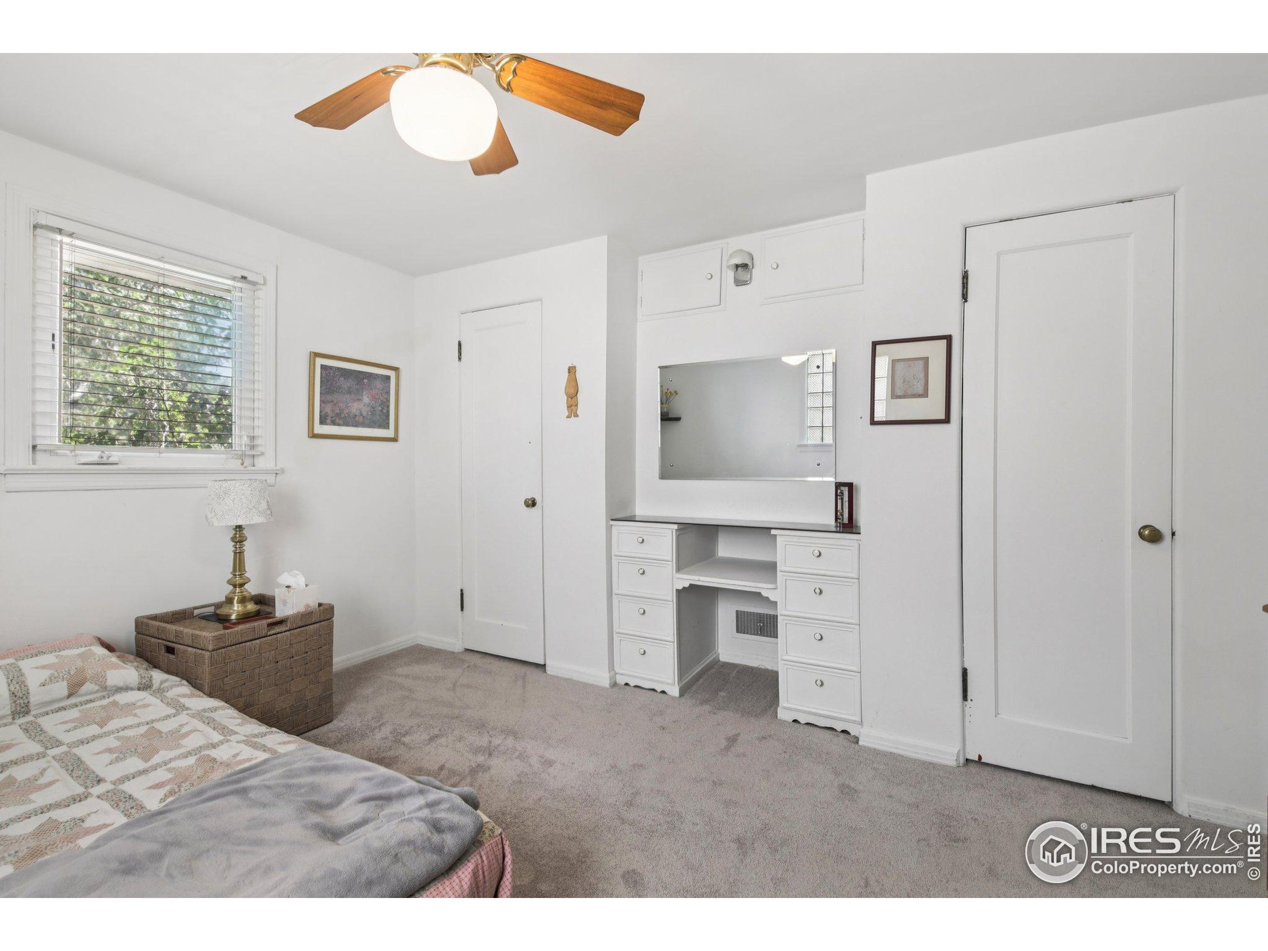 1110 South Quitman Street Denver, CO 80219 - Photo 21 of 43 a spacious bedroom with a bed and cabinets