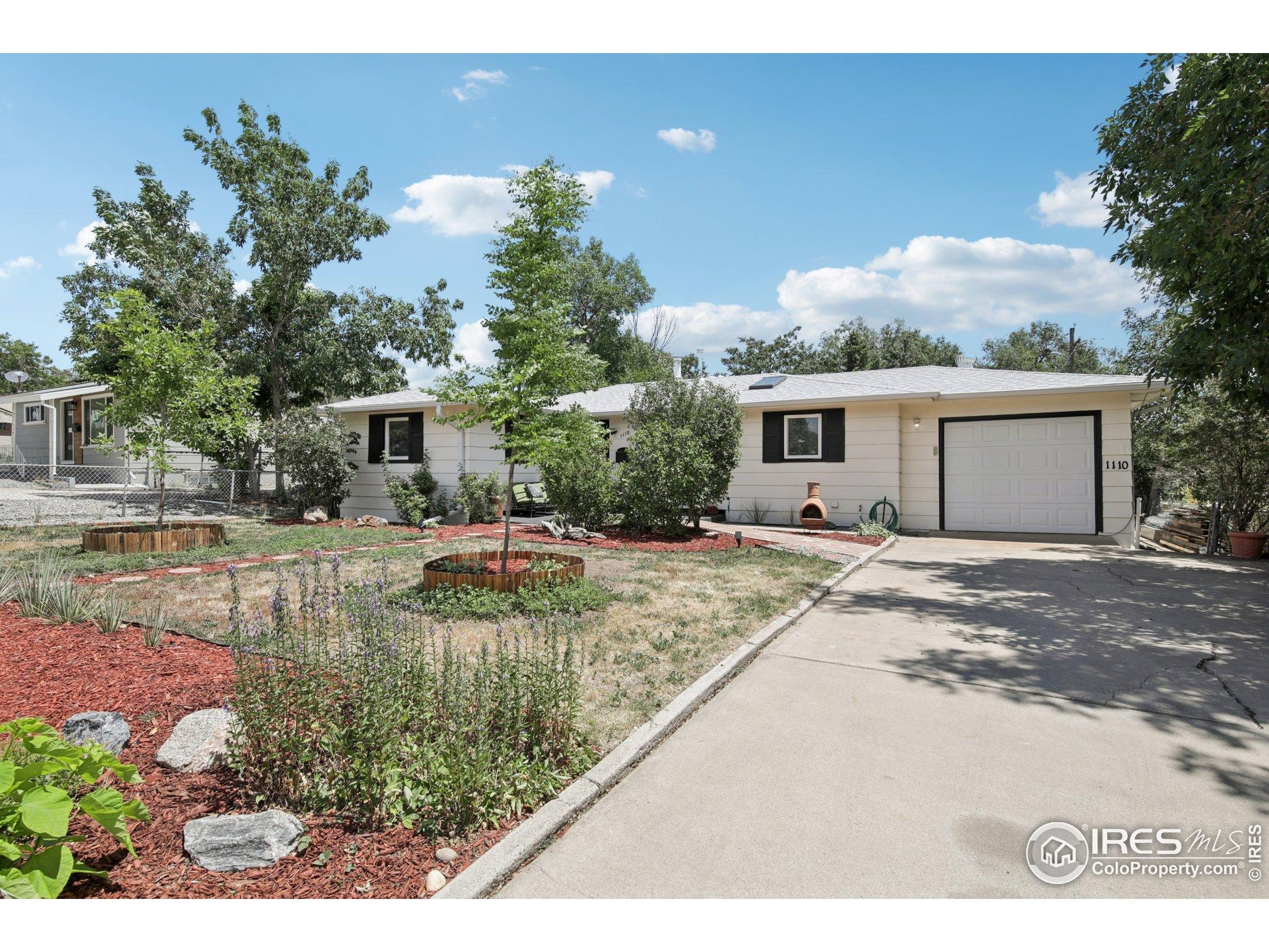 1110 South Quitman Street Denver, CO 80219 - Photo 3 of 43 a view of a house with backyard and sitting area