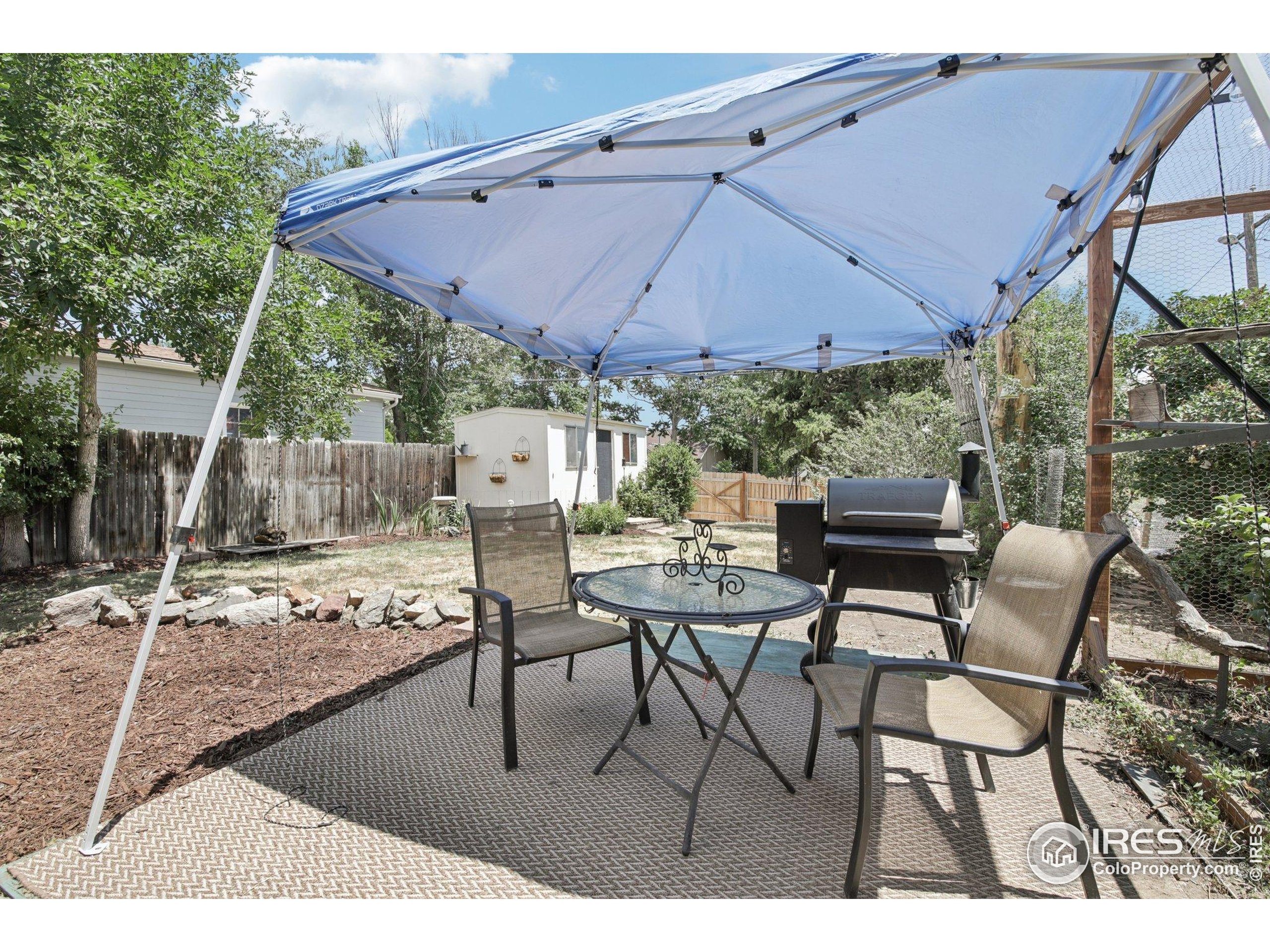 1110 South Quitman Street Denver, CO 80219 - Photo 32 of 43 a patio with tables and chairs