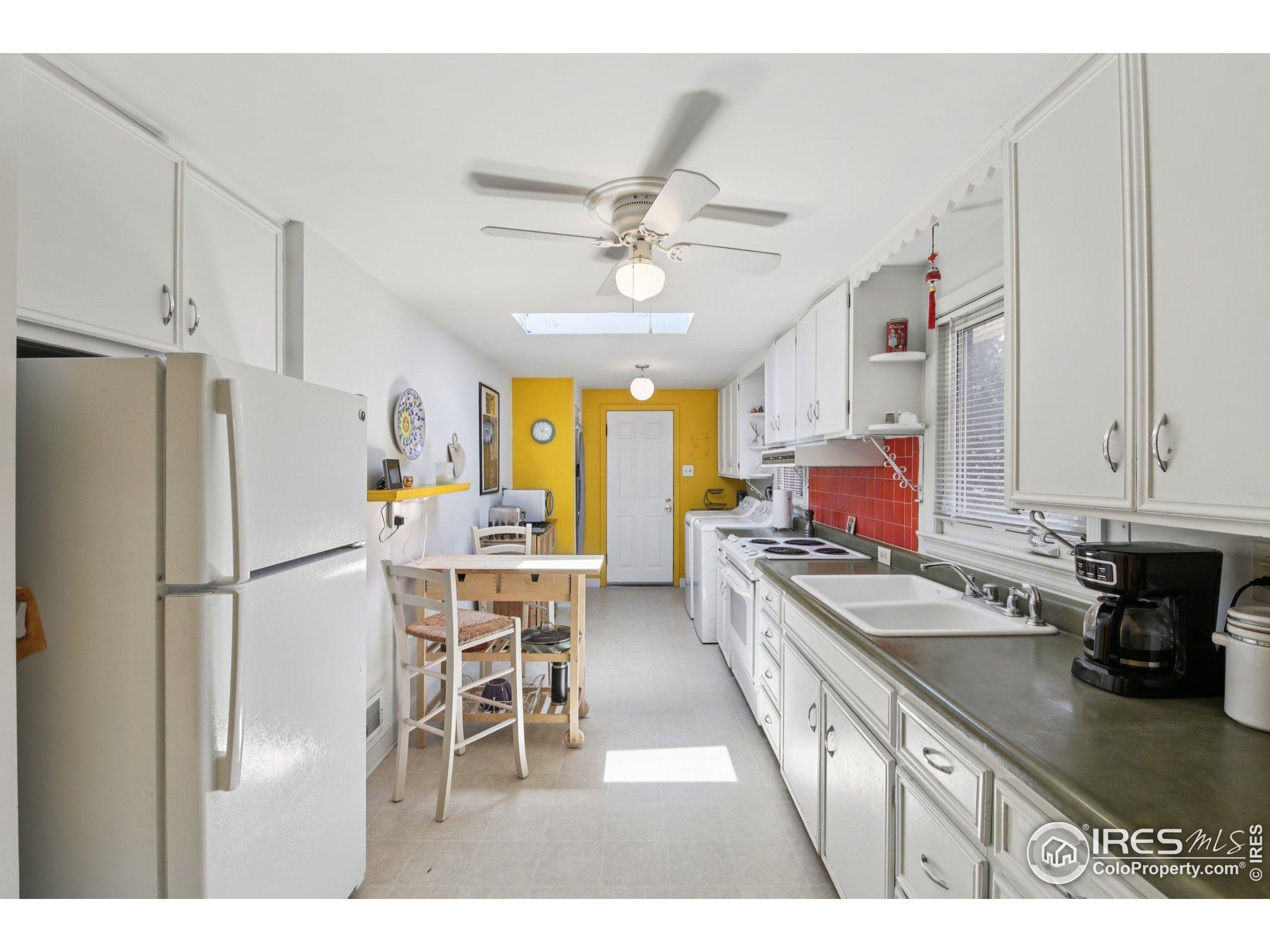 1110 South Quitman Street Denver, CO 80219 - Photo 7 of 43 a kitchen with stainless steel appliances granite countertop a refrigerator a sink dishwasher a stove with white cabinets