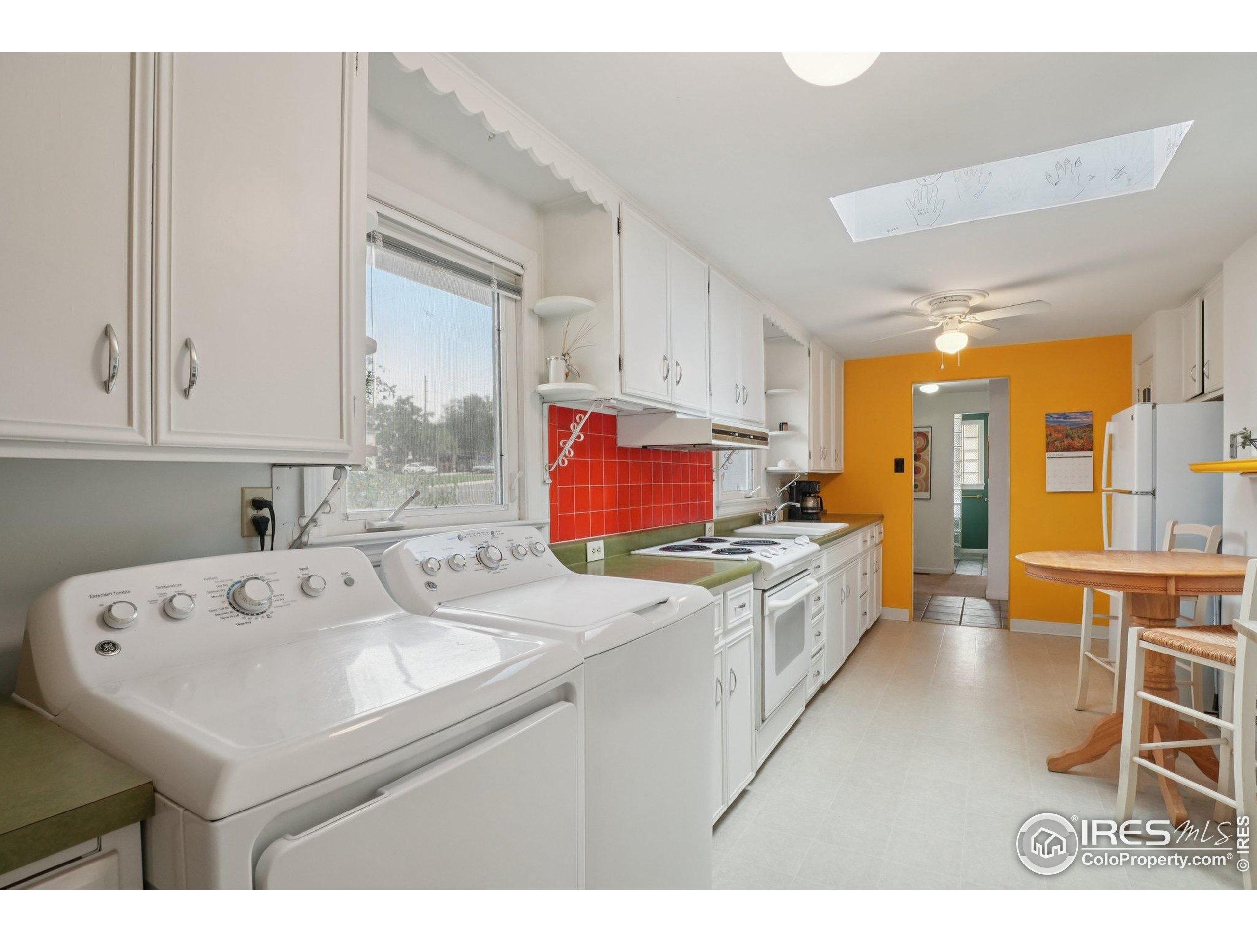 1110 South Quitman Street Denver, CO 80219 - Photo 9 of 43 a kitchen with a sink stove and cabinets