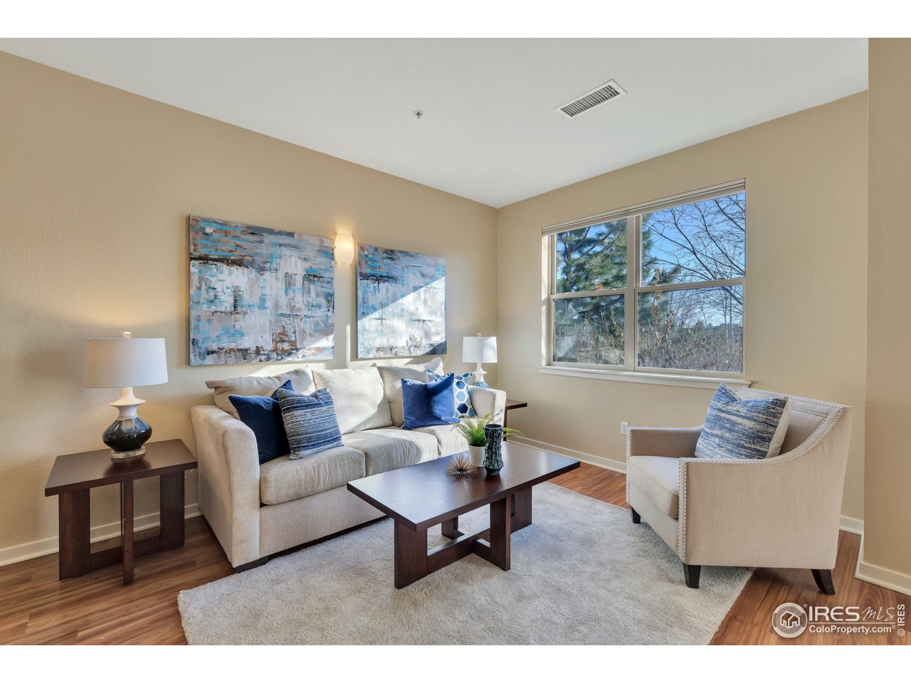2920 Bluff Street, Unit 212 Boulder, CO 80301 - Photo 2 of 21 a living room with furniture and a painting on the wall