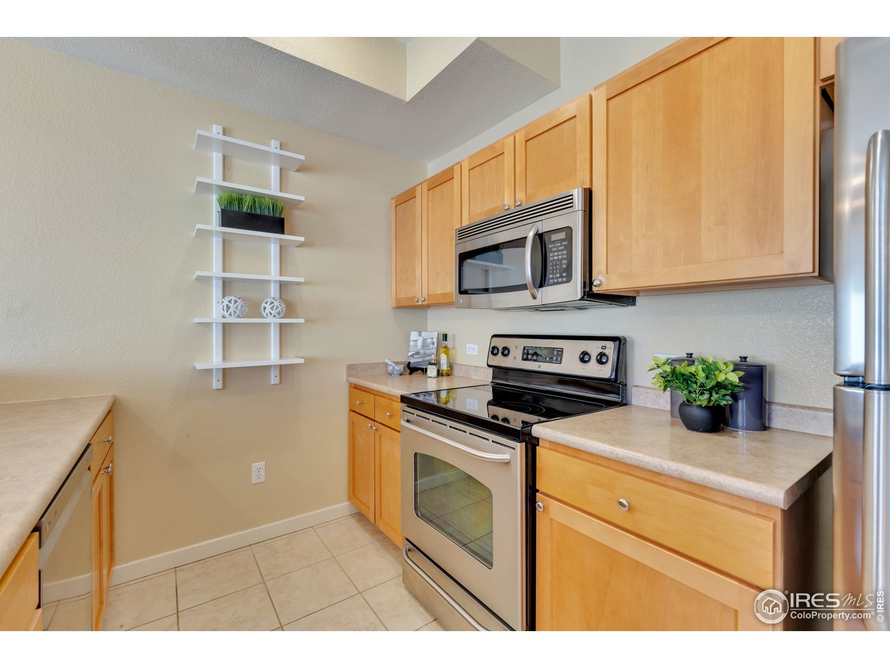 2920 Bluff Street, Unit 212 Boulder, CO 80301 - Photo 8 of 21 a kitchen with stainless steel appliances granite countertop a stove a microwave a sink and cabinets