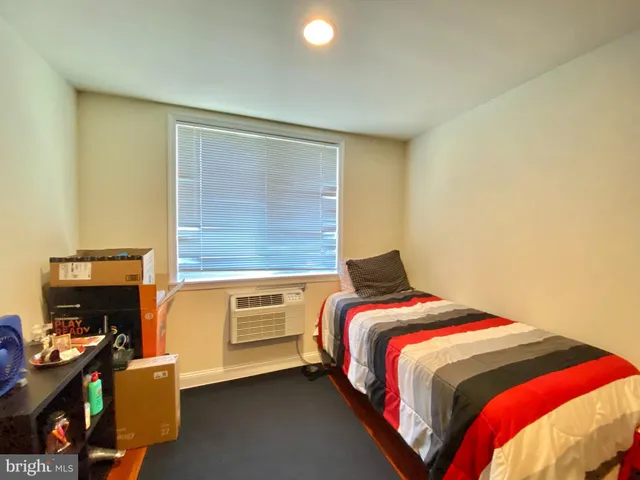 a bed sitting in a bedroom next to a window