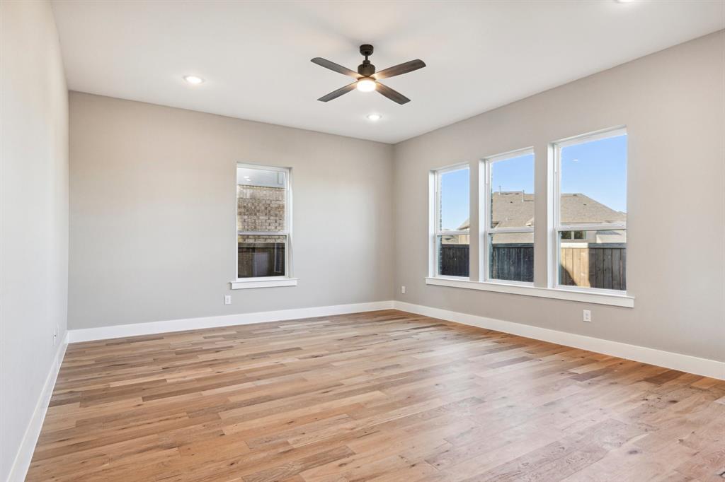 1711 Paytyn Drive Allen, TX 75013 - Photo 8 of 37 Empty room with ceiling fan and light hardwood / wood-style flooring