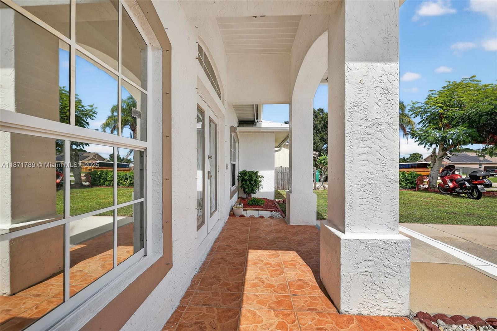 1019 Southwest California Boulevard Port St. Lucie, FL 34953 - Photo 11 of 40 a view of a porch with furniture and garden