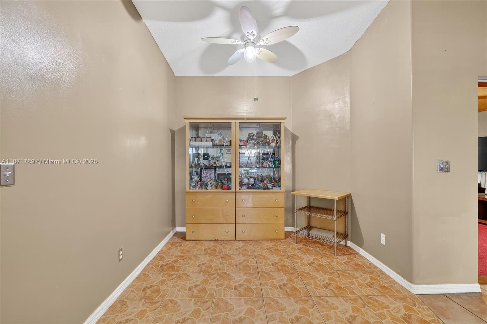 1019 Southwest California Boulevard Port St. Lucie, FL 34953 - Photo 15 of 40 an empty room with a window and ceiling fan