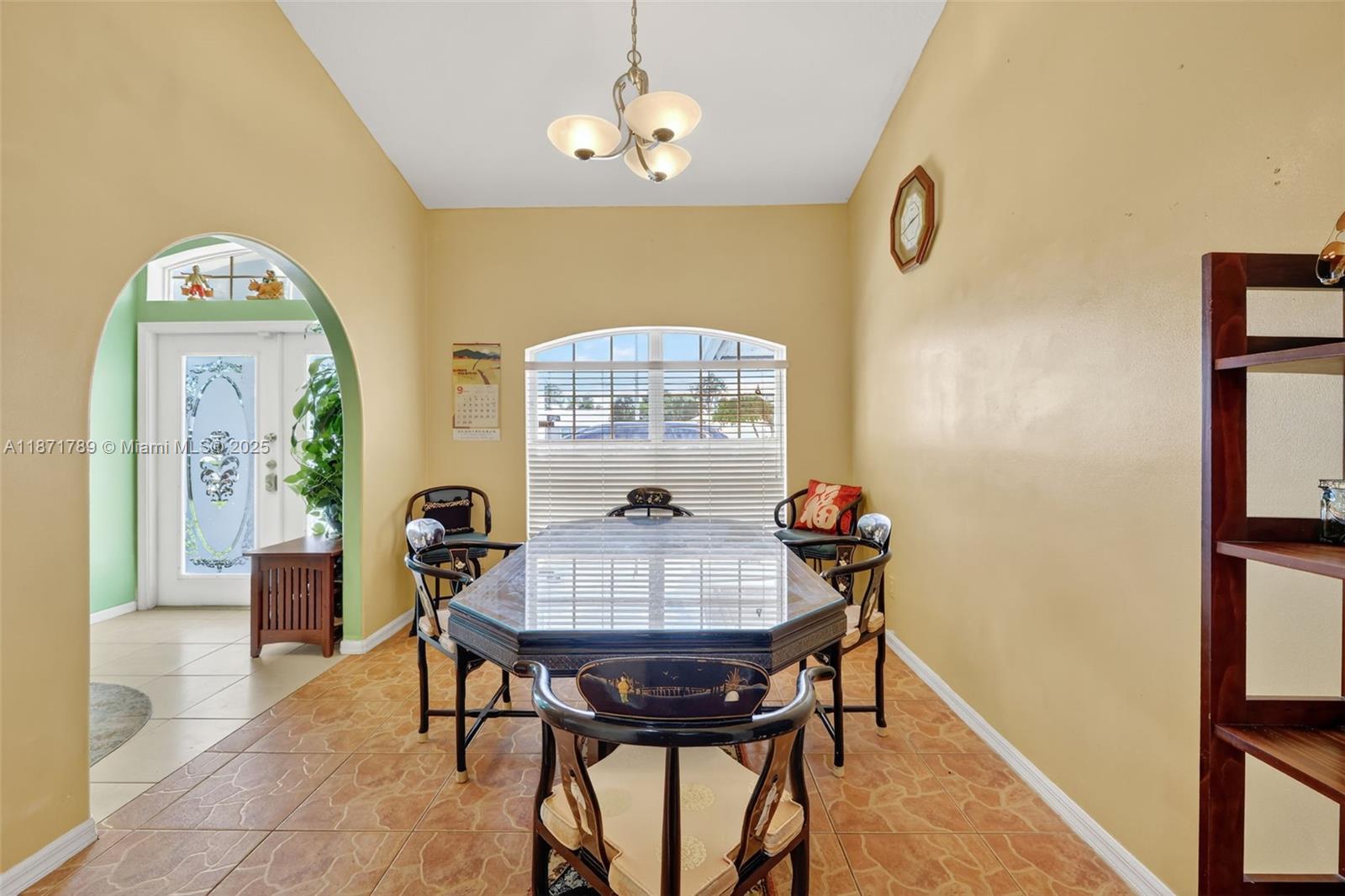 1019 Southwest California Boulevard Port St. Lucie, FL 34953 - Photo 16 of 40 a view of a dining room with furniture and a chandelier