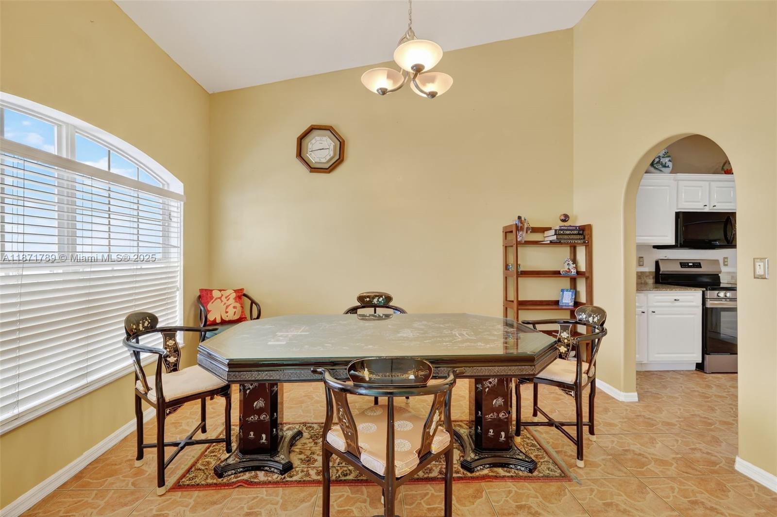 1019 Southwest California Boulevard Port St. Lucie, FL 34953 - Photo 17 of 40 a view of a dining room with furniture and chandelier