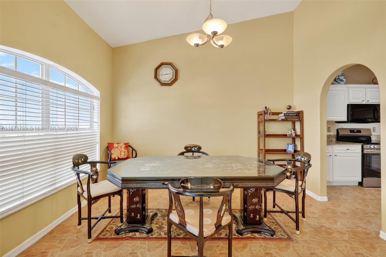 1019 Southwest California Boulevard Port St. Lucie, FL 34953 - Photo 18 of 40 a view of a dining room with furniture and chandelier