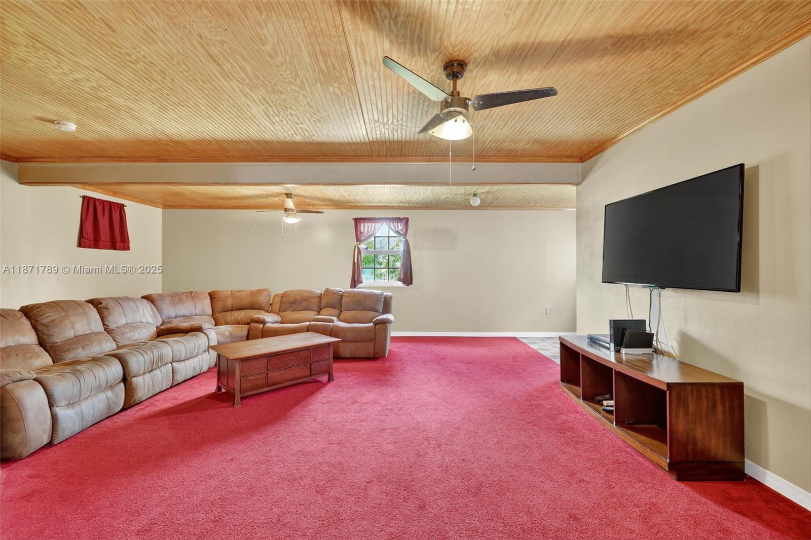 1019 Southwest California Boulevard Port St. Lucie, FL 34953 - Photo 21 of 40 a living room with furniture and a flat screen tv
