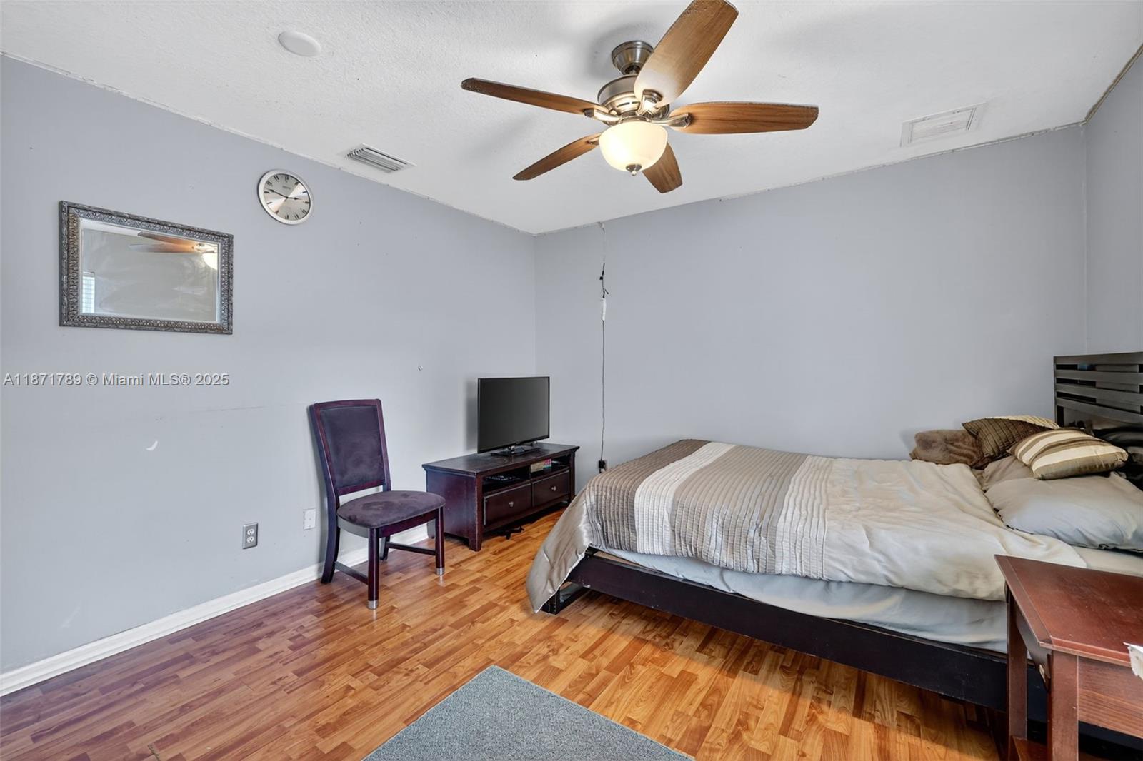 1019 Southwest California Boulevard Port St. Lucie, FL 34953 - Photo 23 of 40 a bedroom with a bed window and a desk
