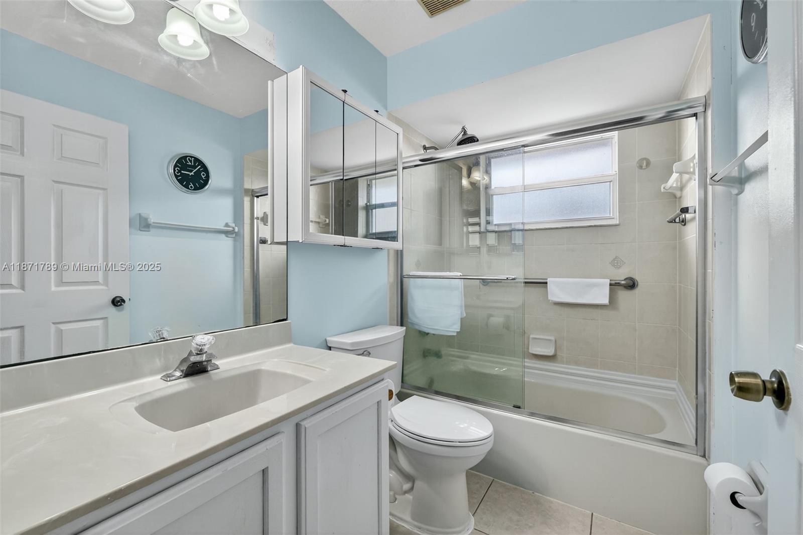 1019 Southwest California Boulevard Port St. Lucie, FL 34953 - Photo 24 of 40 a bathroom with a sink toilet and shower