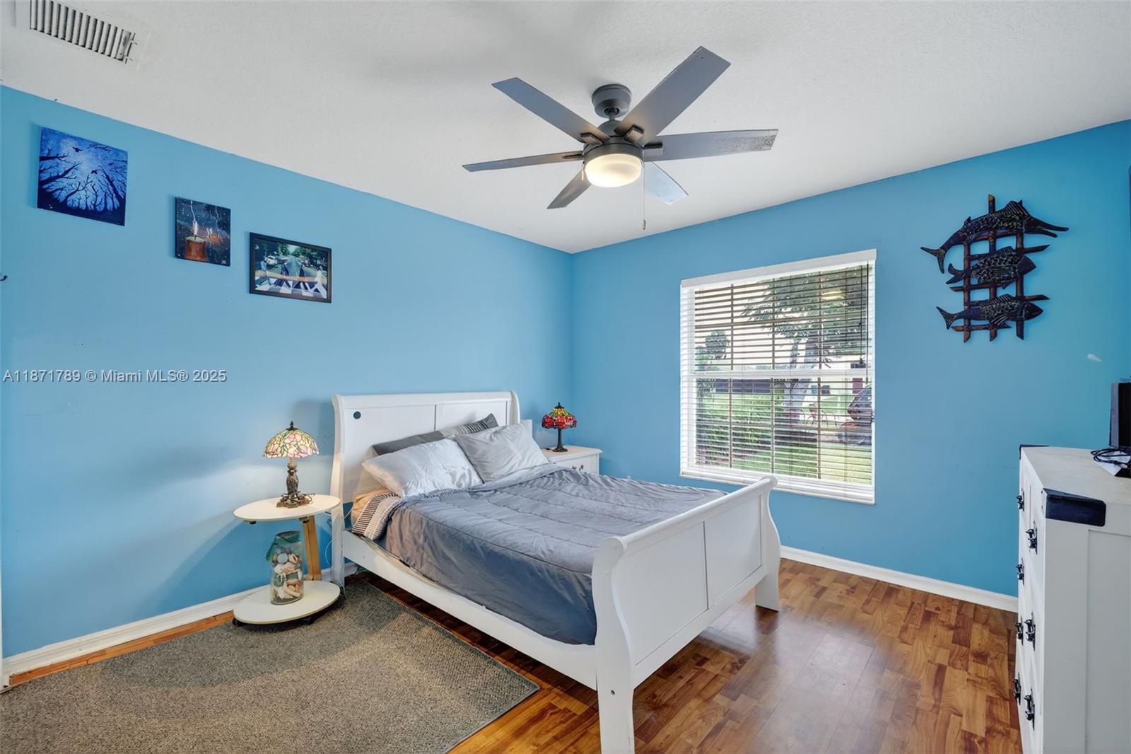 1019 Southwest California Boulevard Port St. Lucie, FL 34953 - Photo 25 of 40 a bedroom with a bed and a window