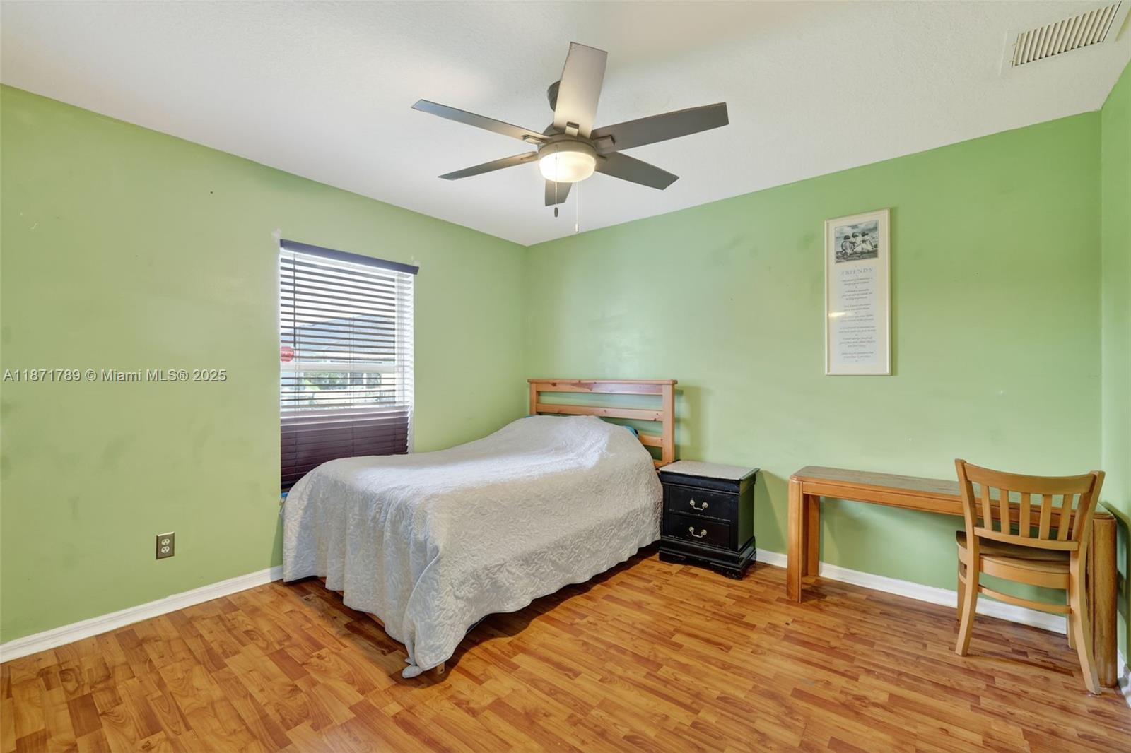 1019 Southwest California Boulevard Port St. Lucie, FL 34953 - Photo 26 of 40 a bedroom with a bed and a table in it