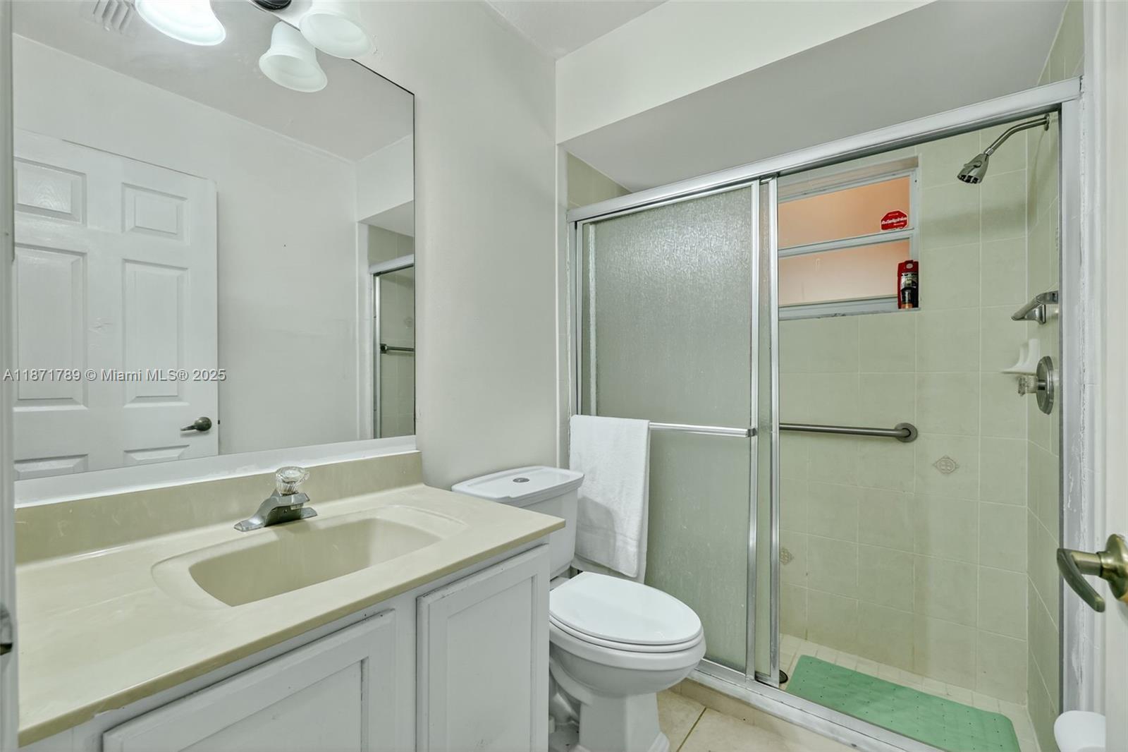 1019 Southwest California Boulevard Port St. Lucie, FL 34953 - Photo 27 of 40 a bathroom with a sink toilet and shower