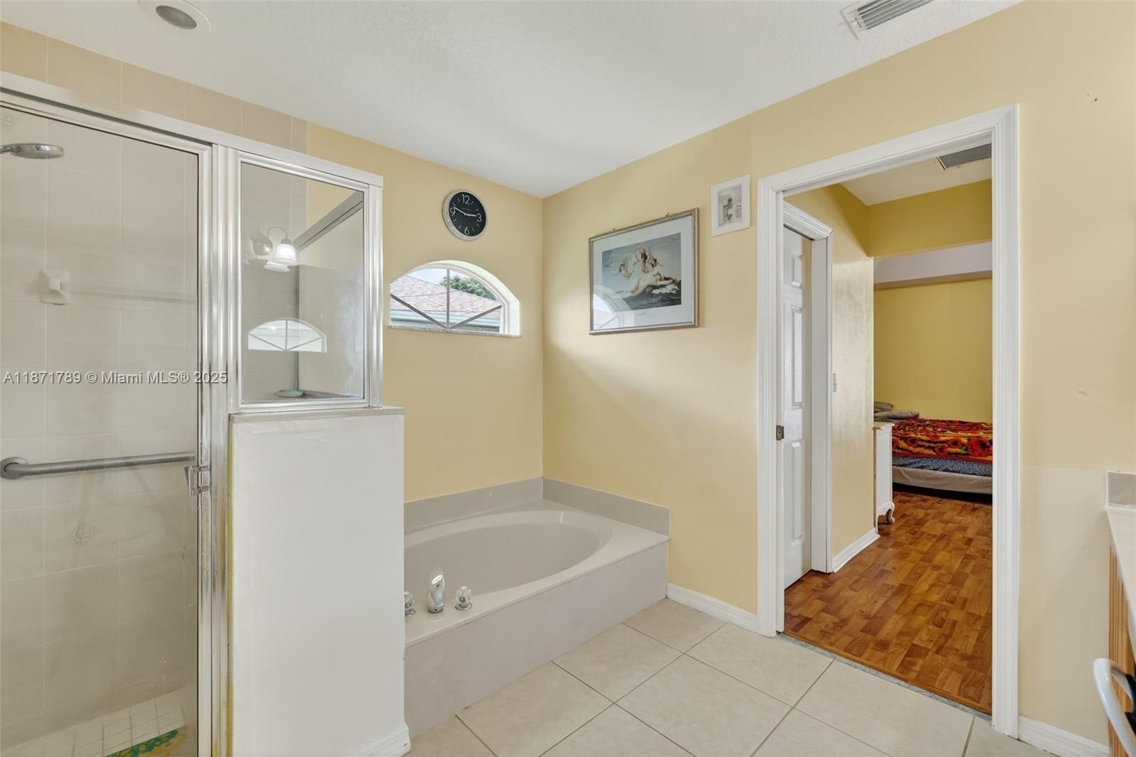 1019 Southwest California Boulevard Port St. Lucie, FL 34953 - Photo 30 of 40 a bathroom with a tub and shower