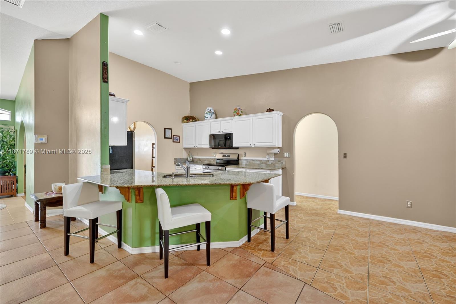 1019 Southwest California Boulevard Port St. Lucie, FL 34953 - Photo 3 of 40 a living room with dining table and chairs
