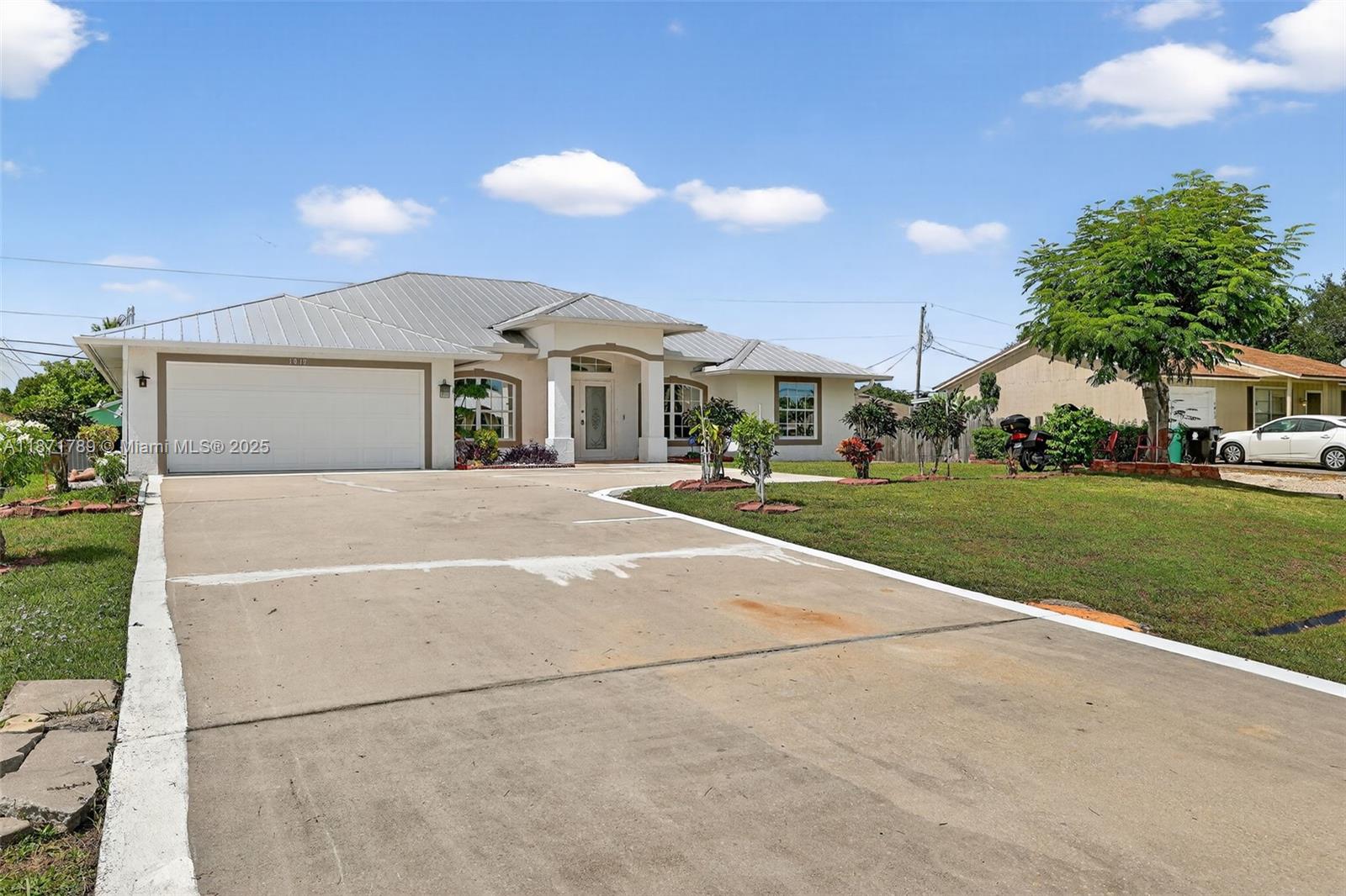 1019 Southwest California Boulevard Port St. Lucie, FL 34953 - Photo 33 of 40 a front view of a house with a yard