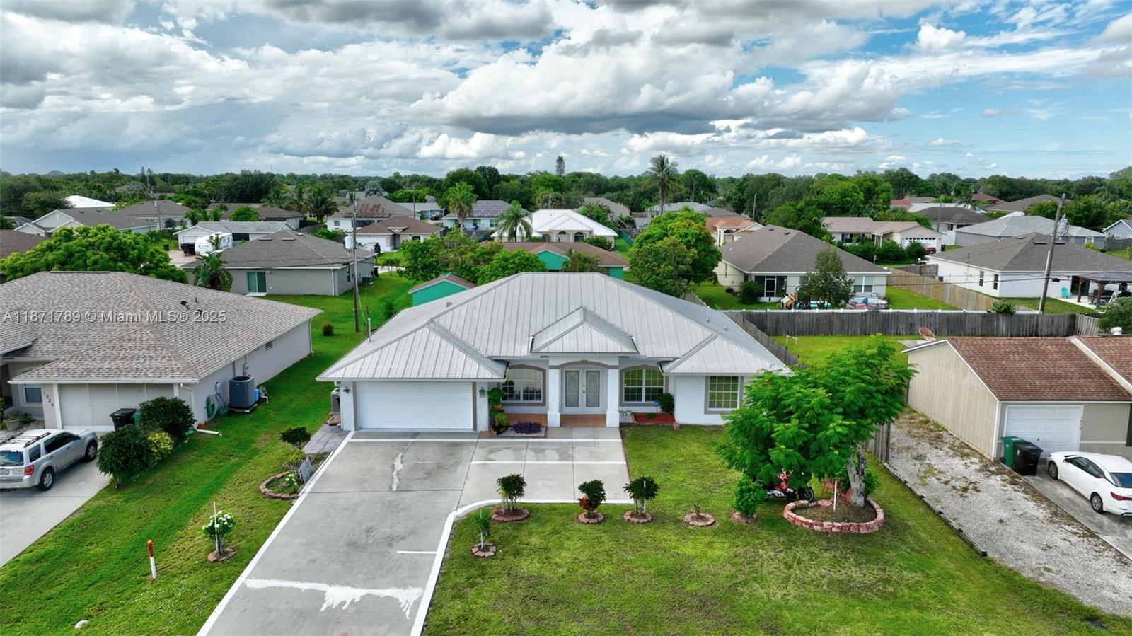 1019 Southwest California Boulevard Port St. Lucie, FL 34953 - Photo 37 of 40 an aerial view of a house with a garden