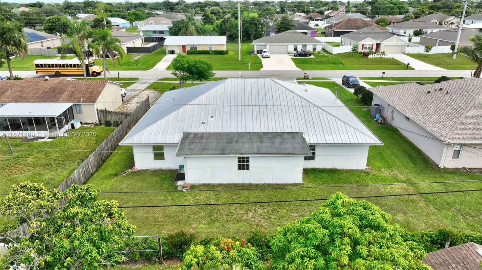 1019 Southwest California Boulevard Port St. Lucie, FL 34953 - Photo 39 of 40 an aerial view of a house with a garden and trees