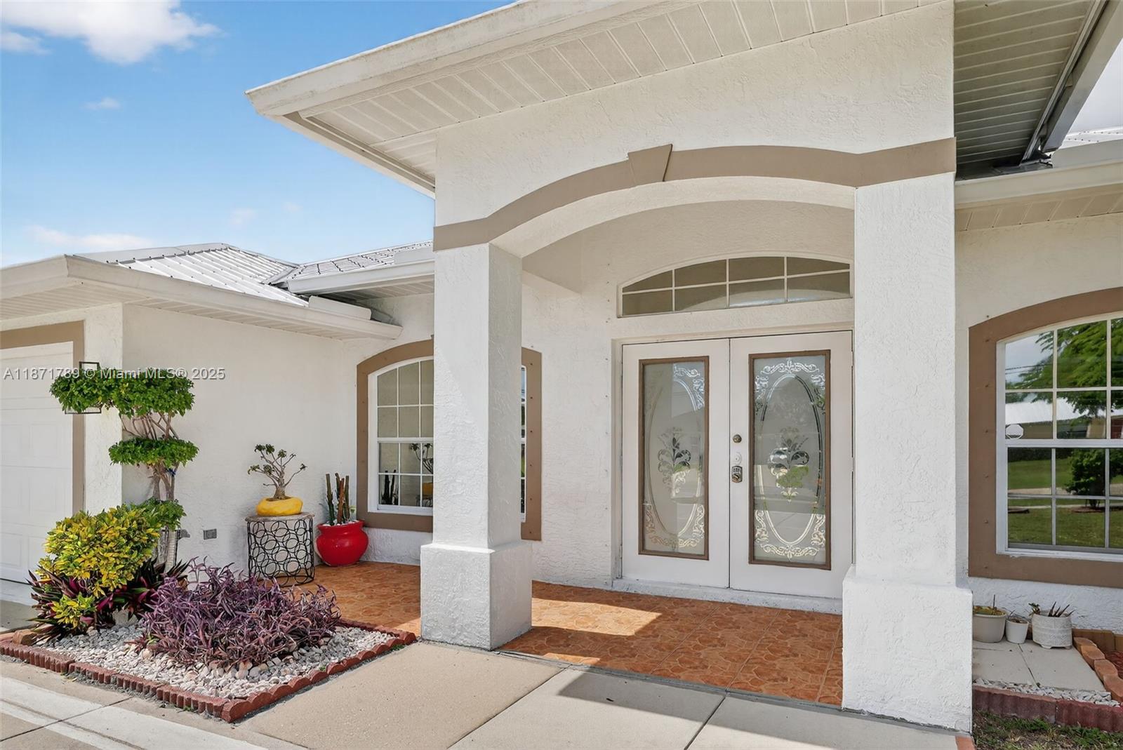 1019 Southwest California Boulevard Port St. Lucie, FL 34953 - Photo 7 of 40 a front view of a house with plants